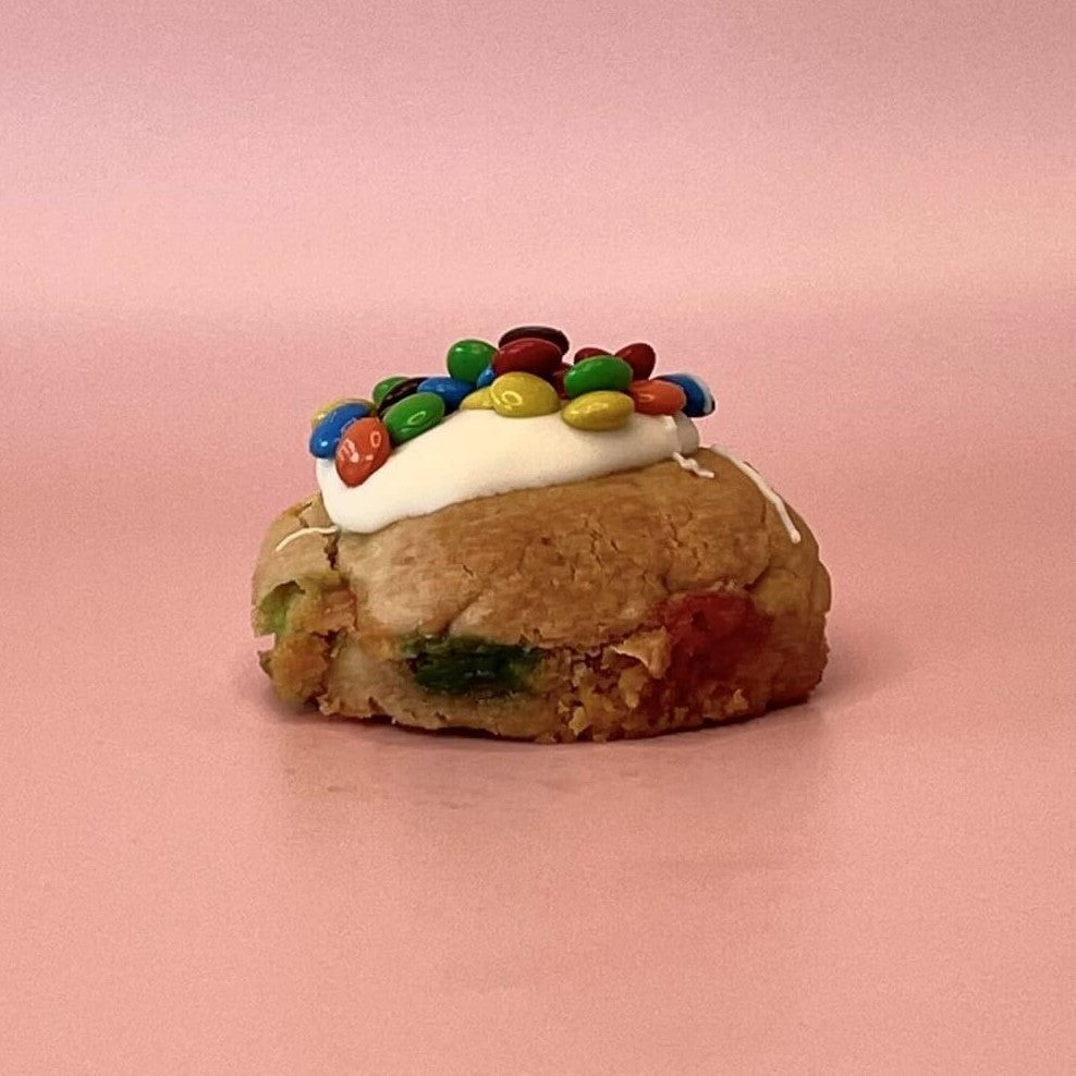 M&M topped loaded cookie with cookie dough filled with M&Ms